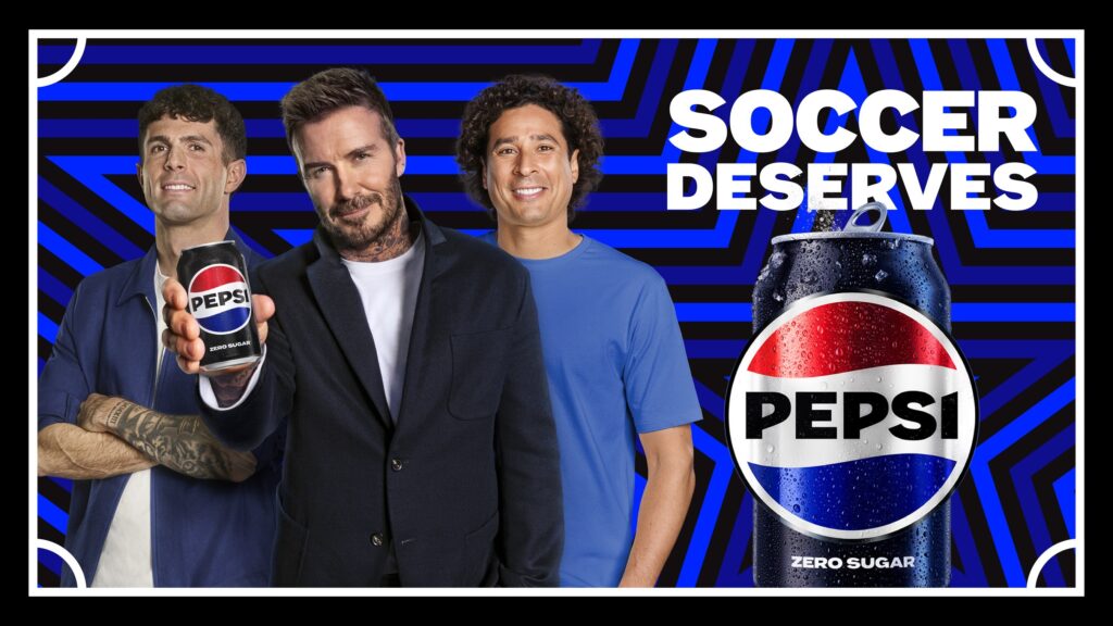 Advertisement with three men and a giant Pepsi can on the right, against a blue geometric background; bold text reads 'SOCCER DESERVES'.