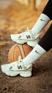 13 July - Consumer Trends – African Marketing Confederation – African Marketing Confederation White athletic sneakers resting on a basketball on a dirt path with autumn leaves in the background.