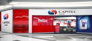 Capitec Bank storefront inside a modern lobby with red glass panels and the bank logo.