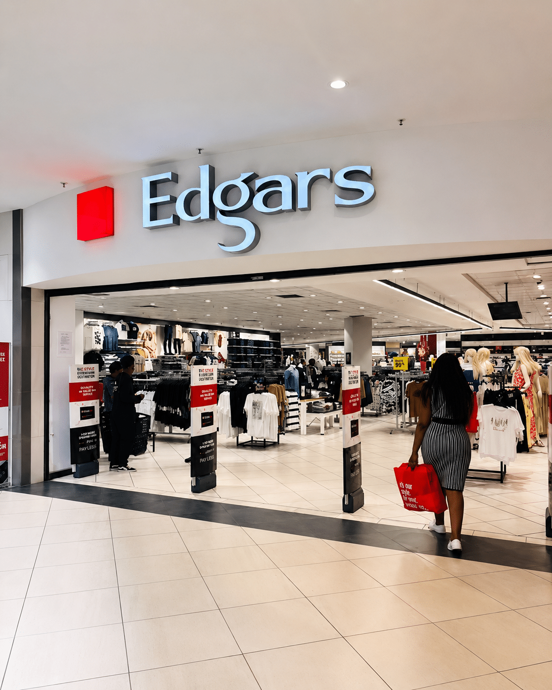 Entrance to Edgars department store in a mall, with clothing racks visible inside and shoppers browsing.