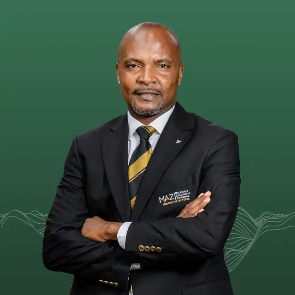 Professional portrait of a man in a black suit with gold striped tie arms crossed green background with wave design